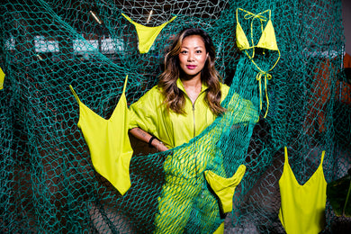 Copenhagen Cartel Founder Katrine Lee Larsen stands with swimwear and fishing nets